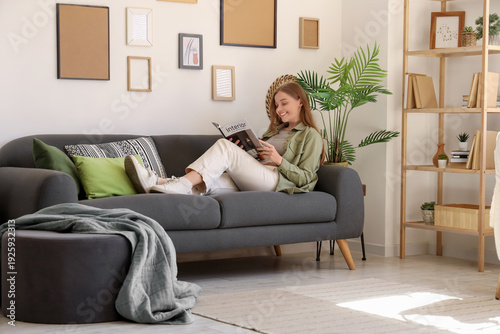 Young woman reading magazin...
