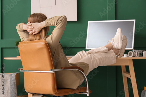 Young woman resting on armc...