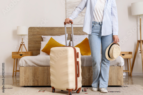 Woman with suitcase and hat...