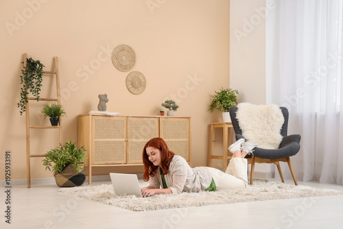 Young woman using laptop on...