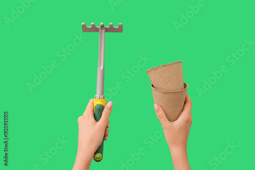 Woman with gardening rake a...