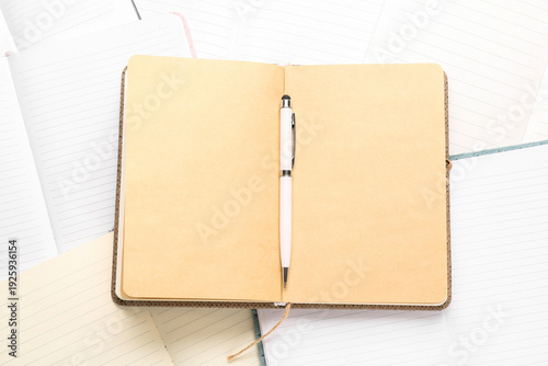 Many open notebooks and pen...