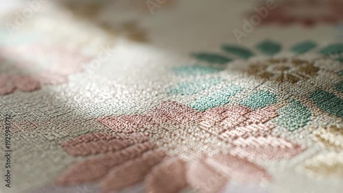Close up floral embroidery on fabric with soft pastel colors