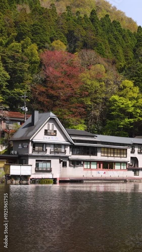 Kinrin lake in Yufuin town, Kinrin-ko lake, Oita prefecture, Japan, hot spring onsen resort town, with mount Yufu, Kyushu island region, rural mountain landscape, a spring day with a blue sky