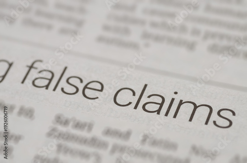 Close-Up of Newspaper Article Featuring Bold 'False Claims' Headline