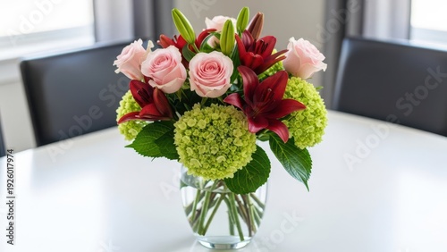 Elegant bouquet of roses and hydrangeas in a clear glass vase on a table