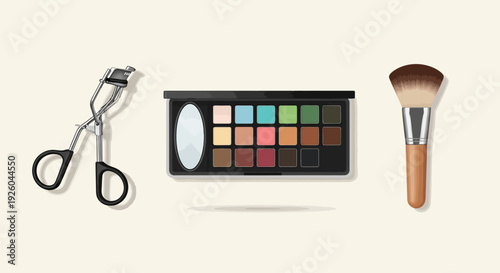 Makeup products arranged neatly on a clean surface with eyelash curler, eyeshadow palette, and brush displayed prominently in a studio setting