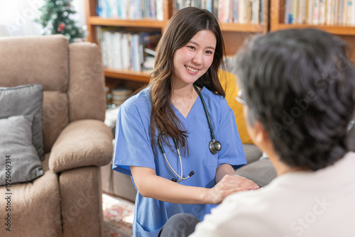 Bilde på lerret Smiling nurse providing home healthcare to senior woman in living room, offering compassionate medical support, elderly care service, and professional in home nursing visit