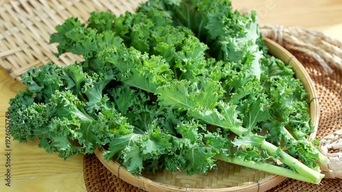 Fresh green kale leaves in woven basket, organic leafy vegetable for healthy eating, vegan diet and clean nutrition concept, natural farm produce close up video