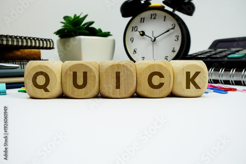 Tableau sur toile QUICK alphabet letters with alarm clock and calculator on white background