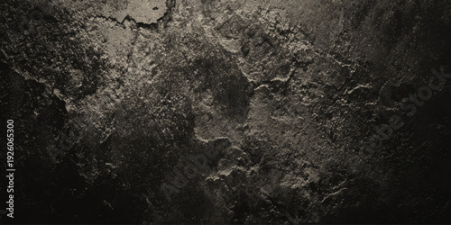 a close up of a dark gray and black textured surface with cracks and crevices