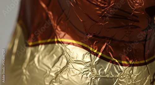 Closeup of crumpled metallic fabric with red and gold colors