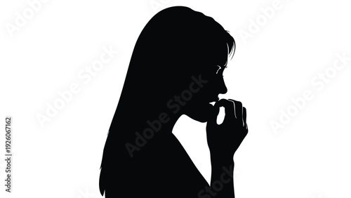 Silhouette portrait of a nervous woman biting her fingernails while dealing with significant worry or anxiety in isolation