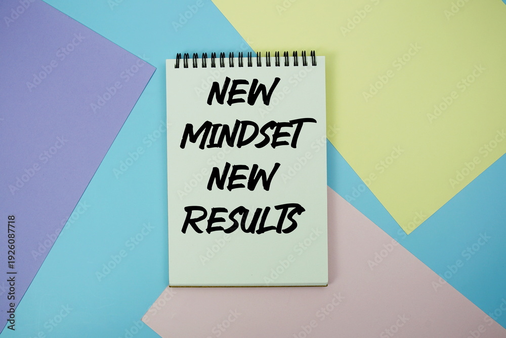 Fototapeta premium New Mindset New Results text written on notepad flat lay on multicolor pastel background