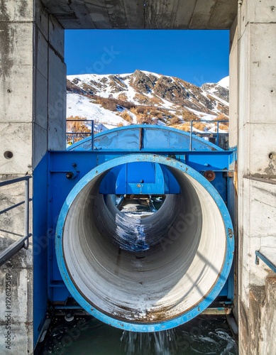 Tunnel View - A Concrete Structure Framing a Snowy Mountain Landscape Under a Blue Sky.