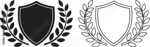 Set of two shield icons with laurel wreaths in solid black and linear outline styles representing security protection victory heritage and award isolated on white