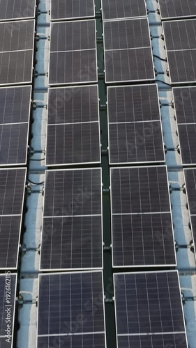 High angle view of floating PV panels and closed-house poultry farm for energy-efficient livestock production.