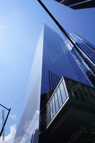 Contemporary Glass Office Tower Against Clear Blue Sky in Manhattan