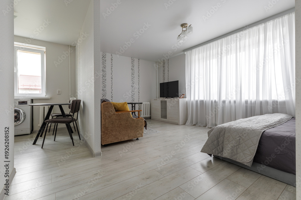 Fototapeta premium Modern Open Plan Studio Apartment with Kitchen and Bedroom