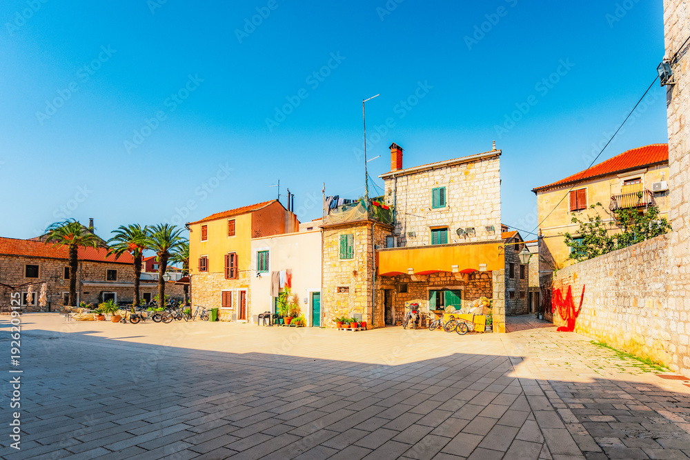 Obraz premium Charming medieval stone streets and the historic Tvrdalj Castle of poet Petar Hektorovic in Stari Grad, Dalmatia, Croatia.
