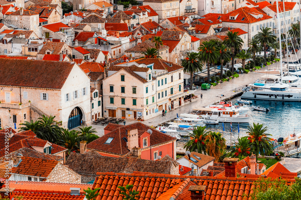 Naklejka premium Traditional Mediterranean stone houses and red terracotta roofs in the historic center of Hvar town, Croatia from medieval Spanish Fortress.