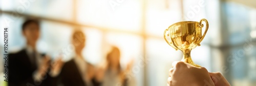 Golden Trophy Award with Blurred Business Team Celebration Background