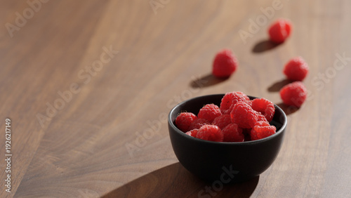 Wallpaper Mural raspberries in black bowl on wood table Torontodigital.ca