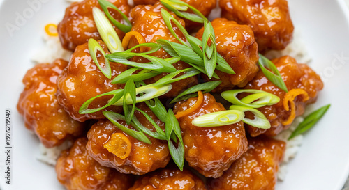 Sweet and spicy fried chicken piled high garnished with sliced scallions