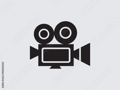 A simple black icon of a vintage film camera on a light gray background