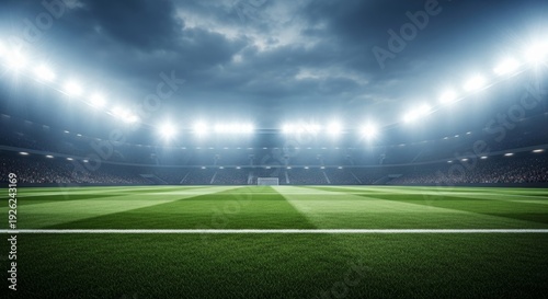 Professional soccer stadium at night with bright floodlights illuminating the green grass pitch under a dramatic cloudy sky during a major sports event with blurred crowd in background.