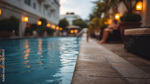 A serene evening by a luxury hotel pool with warm lights reflecting on the water
