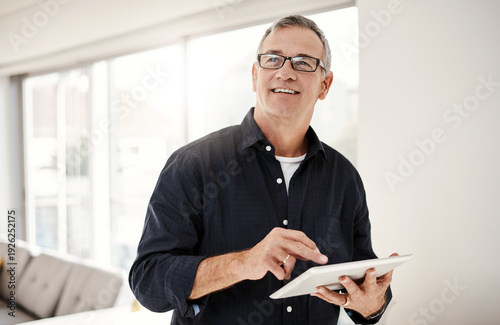 Fotografie Thinking, home and mature man on tablet for investment choice, decision and financial planning