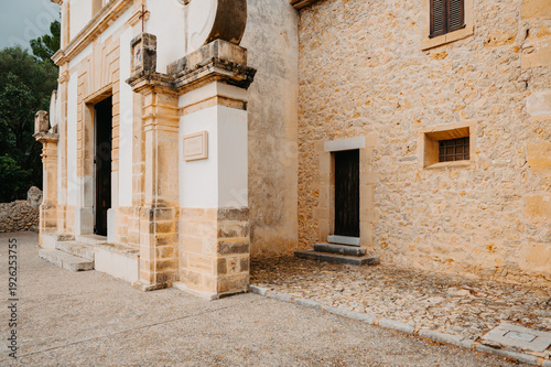 Detail of Eglésia del Calvari facade and adjoining stone house