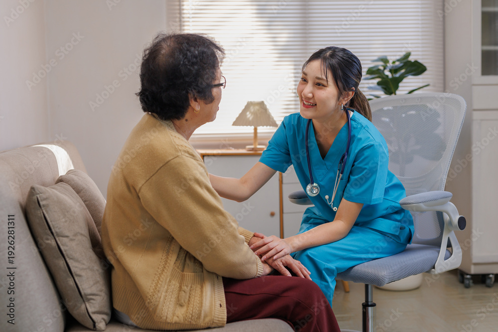 Fototapeta premium Young nurse providing compassionate care to an elderly patient during a home visit, offering support and health assistance