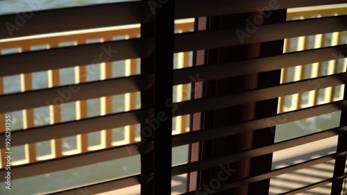 close up of blinds in the dark. abstract background.this blinds is brown on the yellow background. perspective angle of the venetian or wooden blinds.