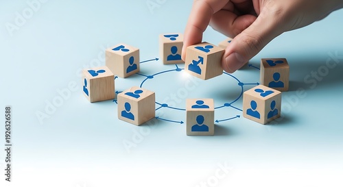Hand placing wooden block with blue people icons into circular network connections