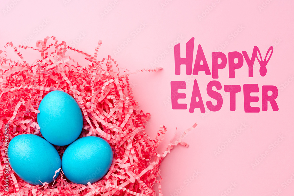 Fototapeta premium Colorful blue eggs in pink straw celebrate Easter holiday festivities and joy