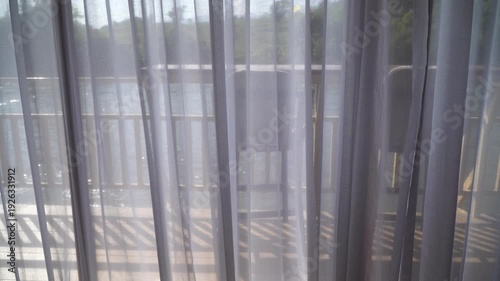 view of the river can be seen through the translucent curtains.