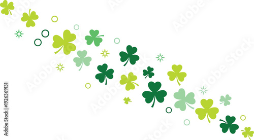 Diagonal stream of various sized green shamrocks and small decorative circles flows across a white background for a festive design.