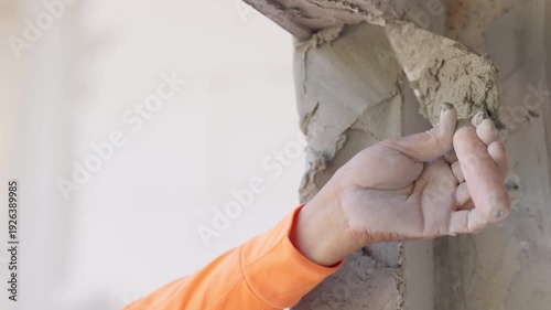 Close up damaged cement plaster on wall corner with rough texture. Construction repair, renovation process and structural maintenance concept with copy space.