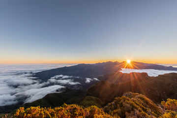 Sunrise over foggy mountains at Miradouro da Bica da Cana, Madeira