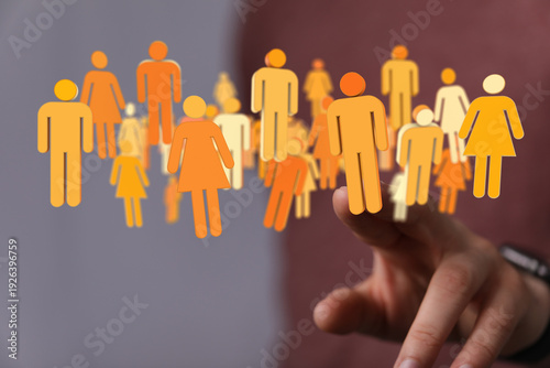 Digitized crowd icon held b...