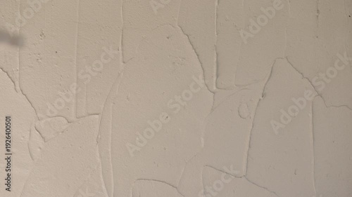 Wet cement plaster applied over concrete block wall during renovation. Industrial construction texture, gray surface background and structural repair concept.