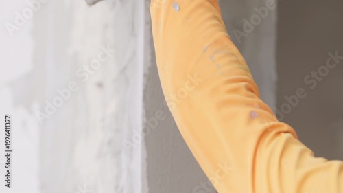 Close up interior wall cement plaster finish with smooth gray texture. Home renovation, building improvement and construction material background concept.