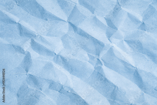 Soft blue crumpled paper texture with natural folds and subtle shadows. Minimal abstract background with gentle light and delicate creases. Calm pastel tone perfect for design, branding, packaging moc