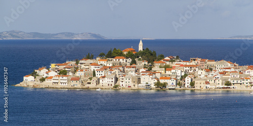 Wallpaper Mural View of a captivating island town with terracotta rooftops and a prominent church tower nestled amidst the deep blue Adriatic Sea, Primosten, Sibenik-Knin County, Croatia. Torontodigital.ca