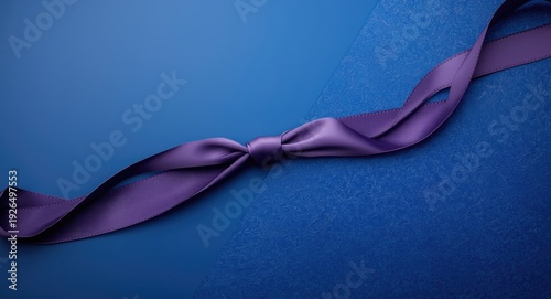 Refined knotted purple ribbon contrasting with a saturated blue textured surface