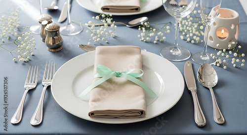 Elegant table setting with green ribbon napkin