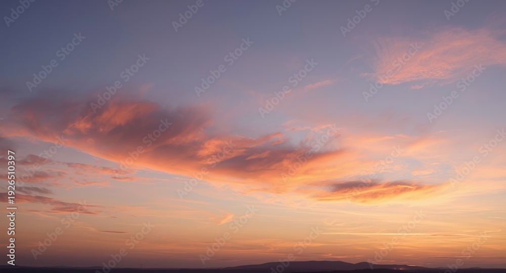 Fototapeta premium Dusk sky illuminated by gentle pastel cloud hues