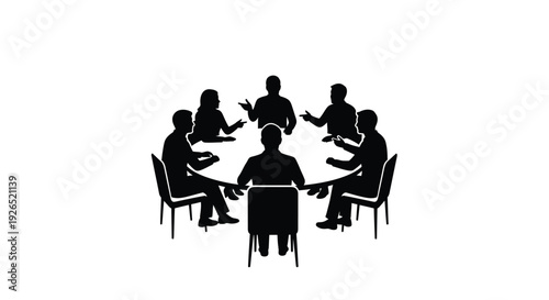 A group of people seated around a table in a meeting